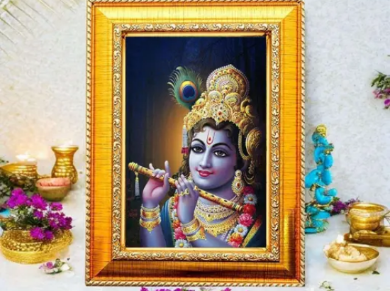 అందమైన ఫ్రేమ్డ్ బేబీ కృష్ణ వాల్ ఆర్ట్ – వైబ్రంట్ డిజిటల్ ప్రింట్, నెమలి ఈక కిరీటం, బంగారు ఆభరణాలు మరియు పూల దండతో శ్రీకృష్ణుడిని ప్రదర్శిస్తుంది, నిర్మలమైన నది మరియు ఆలయ నేపథ్యానికి ఎదురుగా సెట్ చేయబడింది – ఇల్లు, ఆలయం లేదా కార్యాలయ అలంకరణకు సరైనది. యొక్క చిత్రం